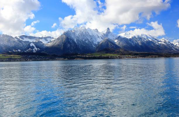 View of Bernese Alps from Oberhofen, located on the northern shore of Lake Thun. Switzerland, Europe. stock photo
