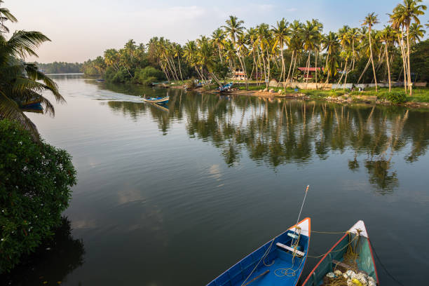 View of canal with boats on sunset. Kerala state, South India. stock photo