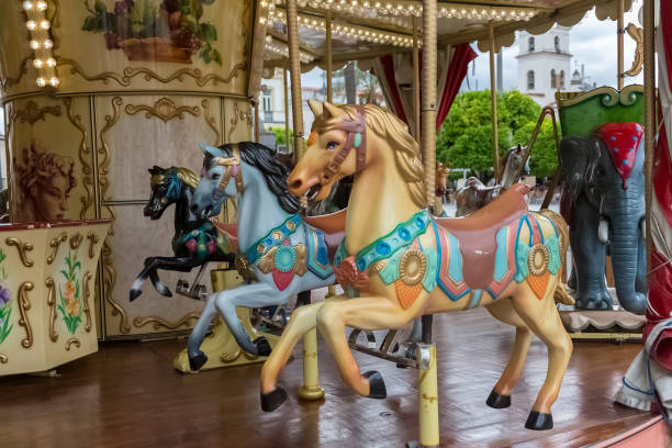 View of colorful horses from a vintage classic carousel stock photo