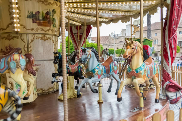 View of colorful horses from a vintage classic carousel stock photo