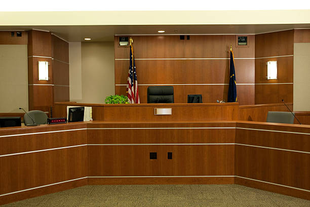 View of Judicial Bench in Modern Courtroom Setting Royalty free image showing a the judge's bench in a modern courtroom setting.  courtroom stock pictures, royalty-free photos & images