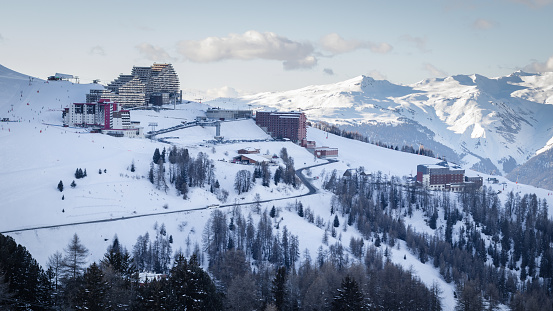 View of La Plagne Aime 2000 ski resort in French Savoy Alps. Snow covered mountains and buildings of ski apartments