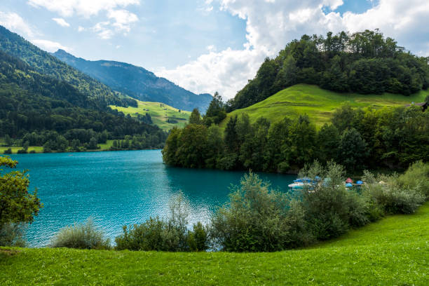 View of Lake Lungern or Lungerersee in Burglen village, Obwalden, Switzerland View of Lake Lungern or Lungerersee in Burglen village, Obwalden, Switzerland. lungern village switzerland lake stock pictures, royalty-free photos & images