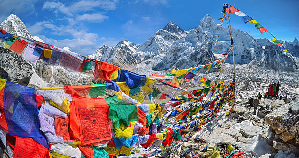 View of Mount Everest and Nuptse  with buddhist prayer flags stock photo