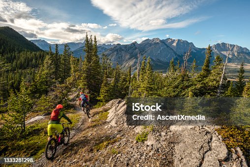 istock View of mountain bikers following trail down mountain 1333281298