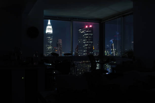 view of night skyscrapers of  new york city (manhattan) through windows of apartment. top view of night midtown of manhattan. usa - window, inside apartment, new york imagens e fotografias de stock