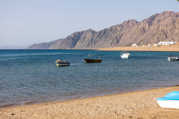 View of Red Sea with boats moored in the port, Dahab, Egypt stock photo