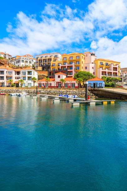 View of sailing marina with colourful houses near Canical town on coast of Madeira island, Portugal stock photo