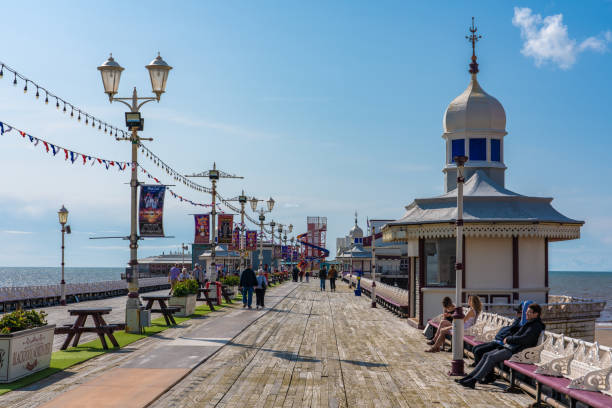 View of the Blackpool North Pier View of the Blackpool North Pier, a popular tourist destination along the seafront on a sunny day on August 12, 2019 in Blackpool north pier stock pictures, royalty-free photos & images