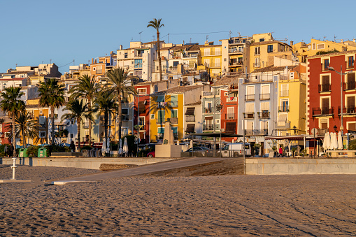 View of the colorful houses of the town of Villajoyosa from its beach at sunrise, Alicante, Spain.