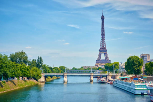 View of the Eiffel Tower from the Seine, with a view of a bridge in panoramic view. stock photo