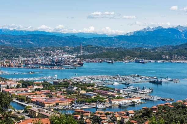 View of the military, commercial dock and ships with mountains of La Spezia in Italy stock photo