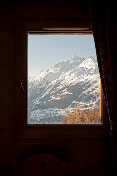 view of the mountains, la rosiere france through a window - rosières stockfoto's en -beelden