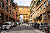 Stockholm, Sweden - May 25, 2021: Horizontal perspective view of the old famous orange vintage building Posthuset with incidental people in Stockholm Sweden May 25, 2021.