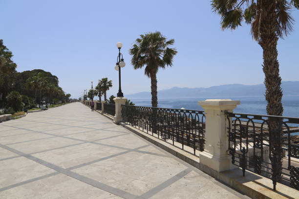 View of the promenade with exotic palm trees in Reggio di Calabria stock photo