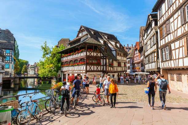 view of the quarter La Petite France in Strasbourg, France Strasbourg, France - September 09, 2018: view of the quarter La Petite France with unidentified people. In the middle ages it was the home for tanners, millers and fishermen. It is a main landmark petite france strasbourg stock pictures, royalty-free photos & images
