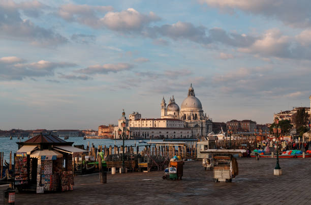 Venice, Italy - February 18, 2020 : A view of the Roman Catholic Santa Maria Della Salute Church and on the left side few people for the carnival stock photo