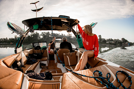 beautiful view of the saloon of a motor boat with people and various wakesurfing equipment