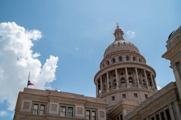 view of the top of the austin capitol building with flag half-staff - lounge horse bildbanksfoton och bilder