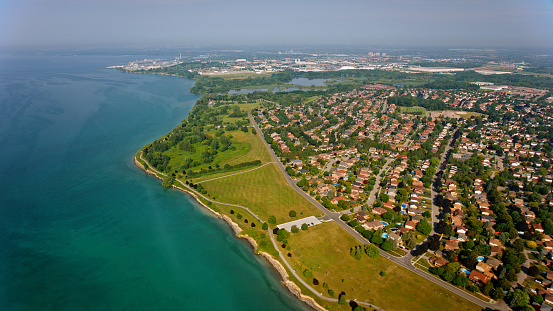 Aerial view of tract housing and lake shore of city of Ajax on a sunny day in Ontario, Canada.