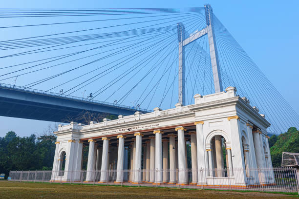 View of Vidyasagar Setu in the backdrop looks amazing with the marble pillars of Prinsep ghat made during the British Raj in 1841. View of Vidyasagar Setu in the backdrop looks amazing with the marble pillars of Prinsep ghat made during the British Raj in 1841. ghat stock pictures, royalty-free photos & images