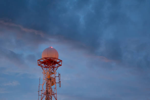 view of Weather radar or weather station with dramatic storm sky and clouds for Satellite communication antenna concept. stock photo