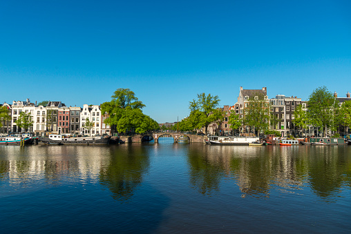 Spring in Amsterdam, the bridge to the Herengracht, early morning, under a blue sky, sunny day.