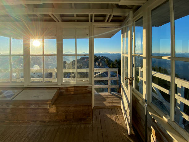 View out the door of mount pilchuck fire lookout at sunrise View out the door of mount pilchuck fire lookout at sunrise in Verlot, Washington, United States fire lookout tower stock pictures, royalty-free photos & images