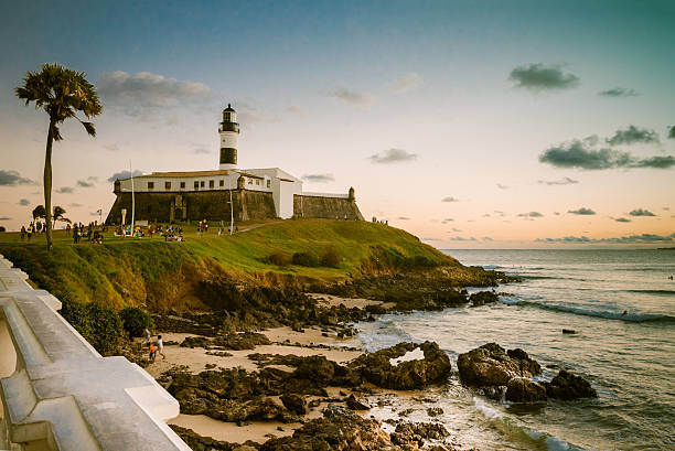 view over coast with lighthouse Farol da Barra in Salvador stock photo