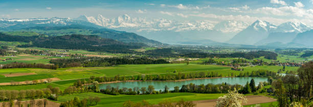 View over lake Gerzen towards Thun and mountain panorama stock photo