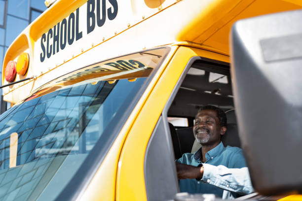 view through side window at mature african american bus driver  school bus driver stock pictures, royalty-free photos & images