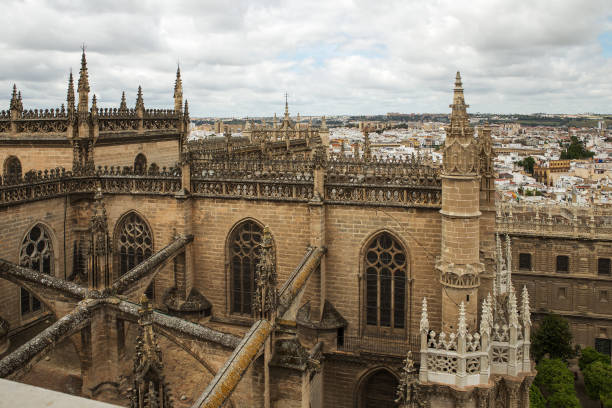 View to Seville cathedral and the city from Giralda belfry Seville, Spain - May, 8, 2019. View to Seville cathedral and the city from Giralda belfry, Spain. The cathedral is the biggest gothic and third Christian church of the world. seville cathedral stock pictures, royalty-free photos & images
