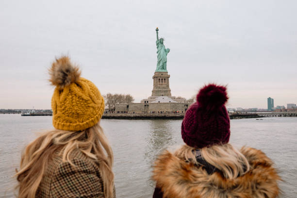 Two women viewing the Statue of Liberty from a tour boat in New York City.