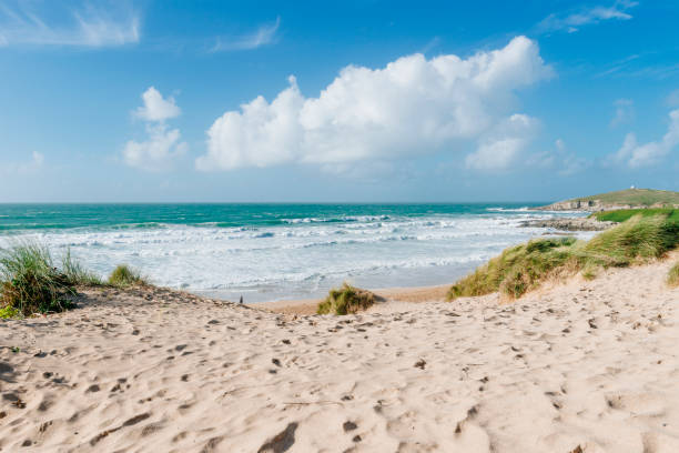 Views across sand dunes to Fistral Beach, Newquay, Cornwall, September. stock photo
