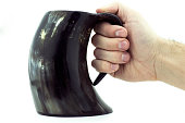 A Viking/Medieval style mug held in a male hand