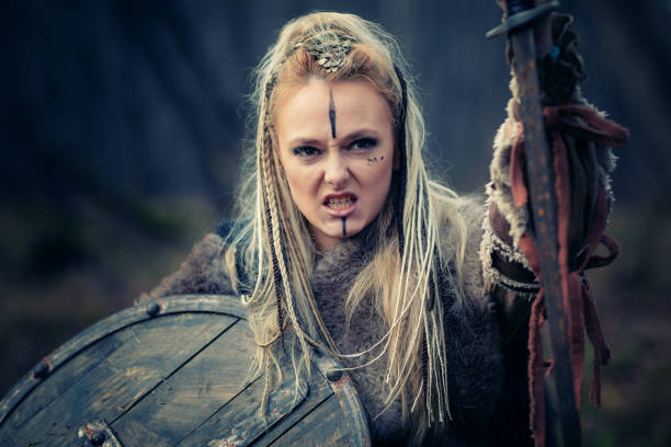 Viking woman warrior in the attack. Sward and shield. Close-up portrait. Book Cover stock photo
