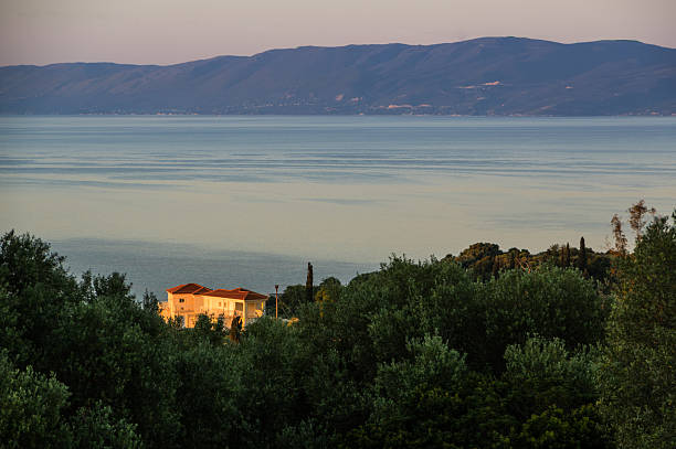 Villa lit by the Greek sunrise stock photo