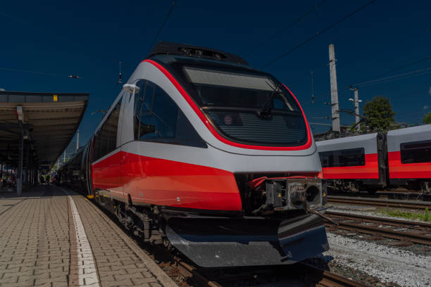 Villach station with electric red passenger unit in summer sunny day stock photo