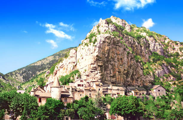 Village in the Gorges du Tarn. Occitania. France. "La Malène" is a French commune located in the department of Lozère and the region of Occitanie. It is part of the Cevennes National Park. The houses are built under the cliff, near the river. gorges du tarn stock pictures, royalty-free photos & images