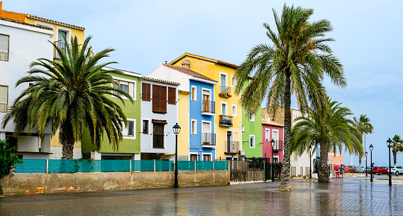 Villajoyosa village, Spain - beautiful colorful houses and palm trees after rain. Popular Spanish tourist destination near Benidorm in Costa Blanca region on Mediterranean sea