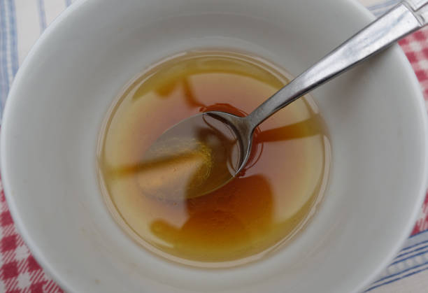 Vinaigrette in a bowl  Oil and vinegar flavored with walnuts stock photo