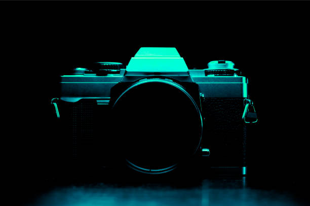 Vintage 35mm slr film camera silhouette in aqua-blue light. Silhouette of a 35mm film camera. Vintage 35mm slr film camera silhouette in aqua-blue light. Silhouette of a 35mm film camera. aqua menthe photos stock pictures, royalty-free photos & images