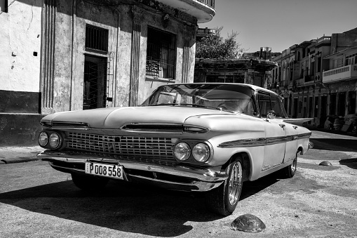 Havana, Сuba - April 19, 2016: Vintage American car, 1959 Chevrolet Impala 4 Door Hard Top Sport Sedan, parked on the street next to colonial buildings in Old Havana, Cuba