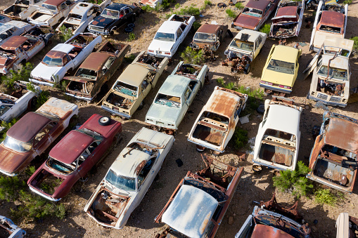 Wrecked, rusty, vintage, American classic cars on a junkyard, aerial view, Arizona, USA.