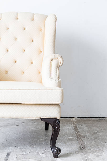 White vintage armchair on white wall.