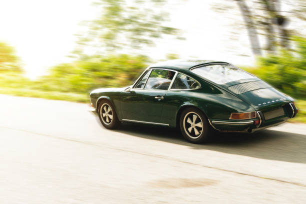 Vintage car: Porsche 911 BIELLA / ITALY - SEPTEMBER 24, 2017: Vintage car running on country road: a Porsche 911 during a meeting of historic cars. This model was built in 1969. porsche 911 stock pictures, royalty-free photos & images