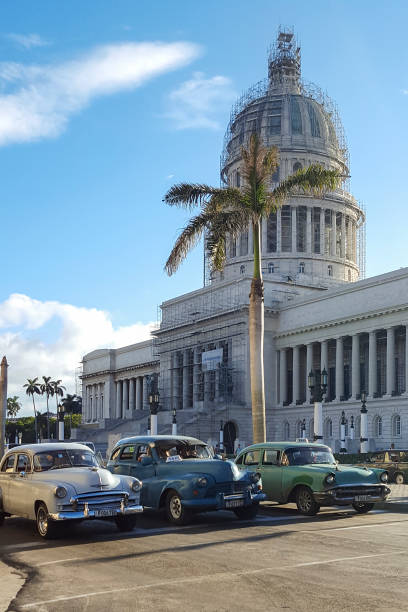 Vintage cars in front of the Capitol of Havana. stock photo