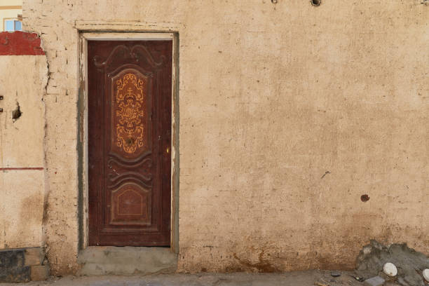 Vintage door and wall in traditional neighborhood of authentic Egyptian street. Grunge background wallpaper stock photo