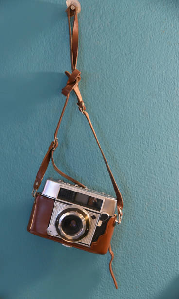Vintage film camera hanging at wall stock photo