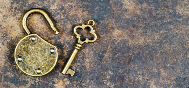 Vintage golden key and unlocked padlock on a rusty metal background, escape room concept Escape room concept. Web banner of a vintage golden key and unlocked padlock on a rusty metal background. escaping stock pictures, royalty-free photos & images